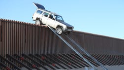 Two would-be smugglers attempting to drive into Arizona from Mexico hit a roadblock when their jeep gets stuck on the border fence.